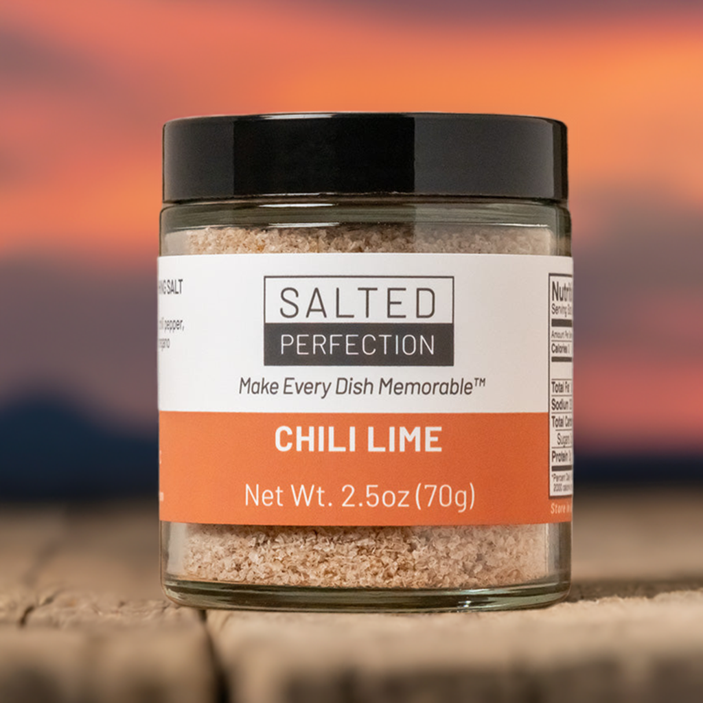 Jar of chili lime salt on a wooden table at sunset in the desert Southwest